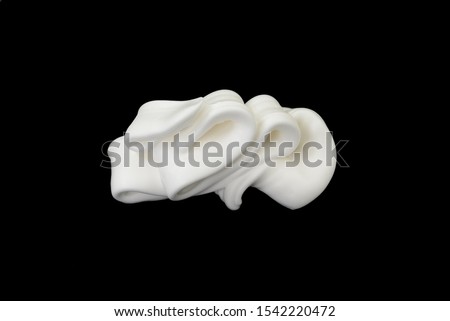 whipped cream or meringue isolated on black background.  Royalty-Free Stock Photo #1542220472