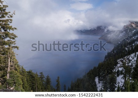 A view of crater lake in Oregon on a foggy day.