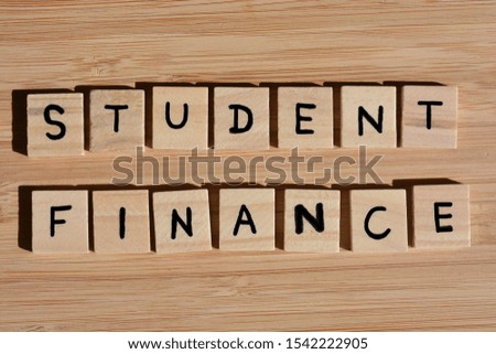 Student Finance, Word in 3d wooden alphabet letters on a wooden bamboo background