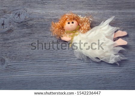 Christmas angel decoration on a wooden background