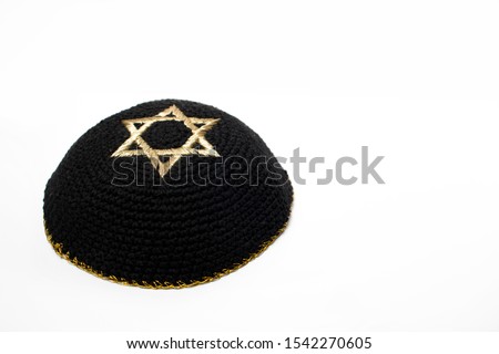 Israeli black Kippah with the david star on the top with a white background. Royalty-Free Stock Photo #1542270605