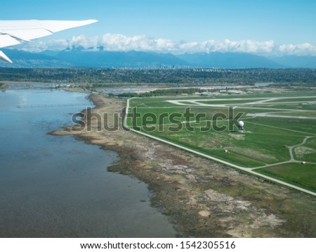 Aerial view of International Airport of Vancouver (VVR) and downtown