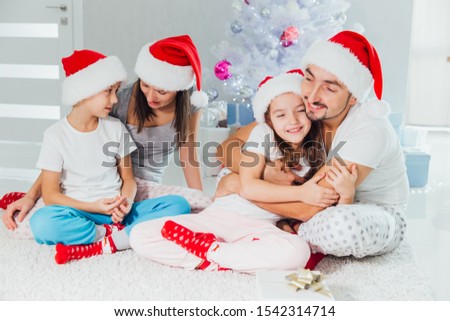 Christmas picture of beautiful family. Christmas time