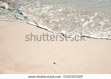 On the picture is Pacific Ocean Long Beach shore. Azure blue sea water disappears in the sand.
