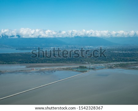 Aerial view of International Airport of Vancouver (VVR) and downtown