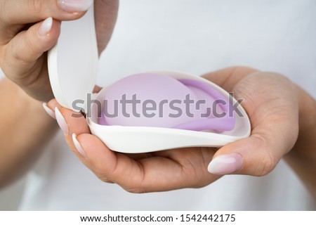 Photo Of Woman Holding Diaphragm For Contraceptive Use Royalty-Free Stock Photo #1542442175