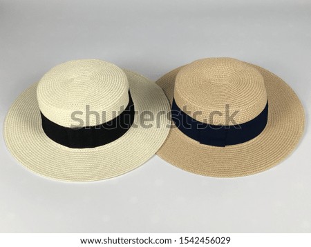 White fashion hat with cream on a white background.
