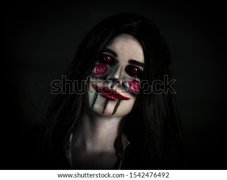 Face of a girl with halloween  monster make up on black background