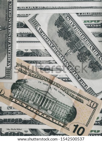 Many 100 dollar bills and one 10 dollar bill.. The concept of sustainable world currency rates. USD close-up photo. Finance and economics.