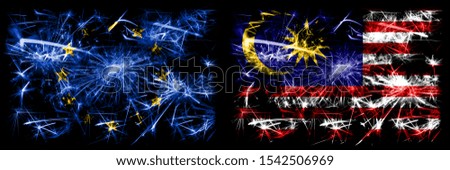 Eu, European union vs Malaysia, Malaysian new year celebration sparkling fireworks flags concept background. Combination of two states flags.
