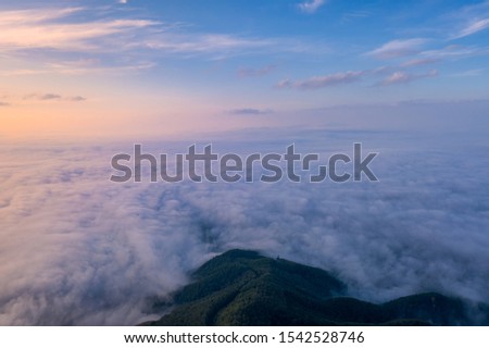 Landscape of Morning Mist with Mountain Layer. Mountain view morning of Top hill around with the ocean of mist with clouds moving in cloudy sky background. Mist over the mountaintop.