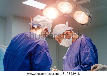 Two Surgeons work inthe operating room. Patient's tretment. Health care consept. Closeup.