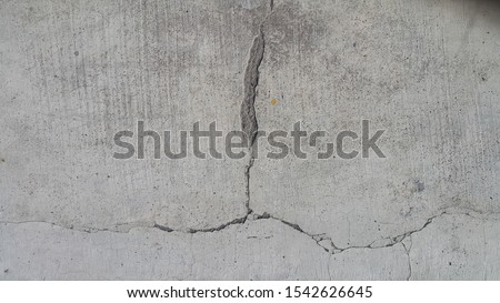 concrete cement wall texture background with cracked junction