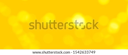 Abstract background  of yellow colors and sparkling white bokeh.