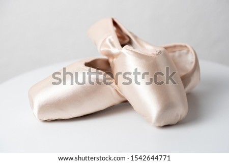 Ballet shoes on white table
