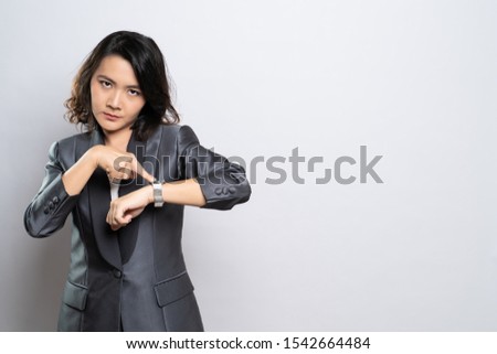 Angry woman pointing at her watch