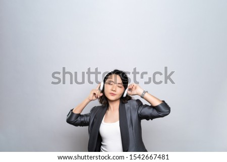 Happy woman with headphones and listening to music isolated on white background