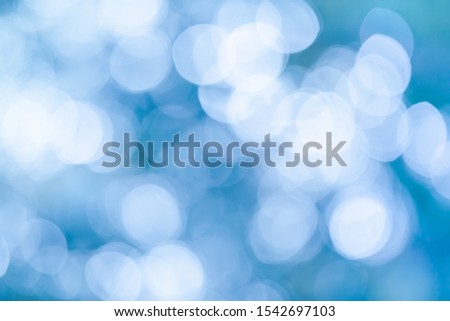 Abstract blurred blue background for Christmas or winter concept. Festive blurred winter effect. Nature bokeh.