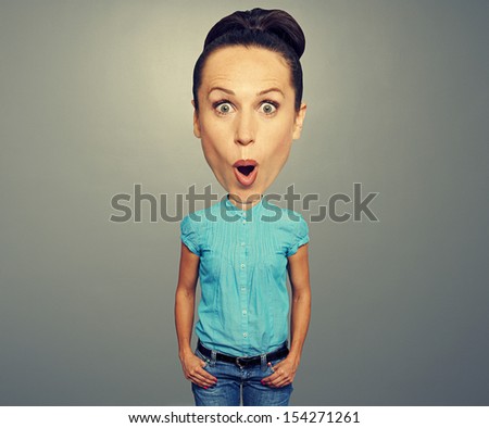 amazed woman with big head over grey background