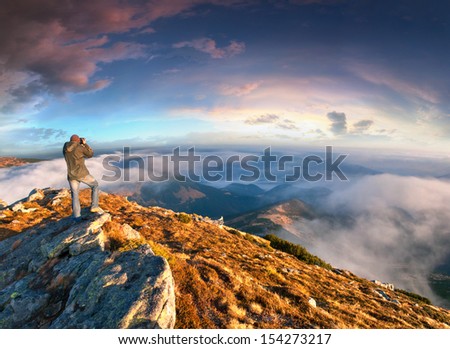 Photographer takes a sunset in the mountains
