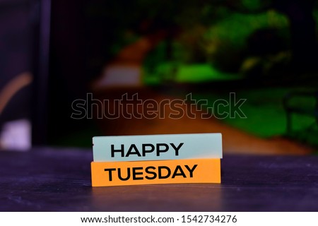 Happy Tuesday on the sticky notes with bokeh background