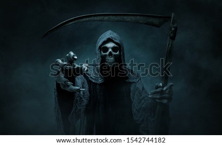 Grim reaper reaching towards the camera over dark, misty background with copy space Royalty-Free Stock Photo #1542744182