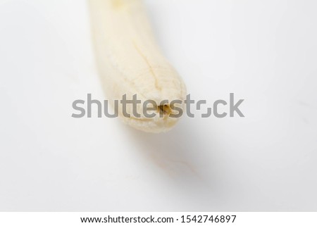 Ripe peeled banana on a white background isolate