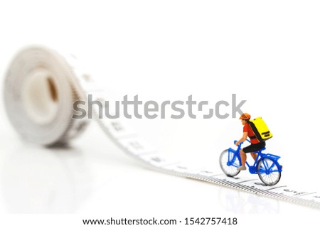 Miniature people enjoy riding a bicycle. Cycling for health Concept.