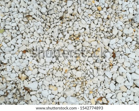Light gray stone rubble as background of many small stones
