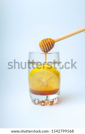 A picture of lemon honey drink that is good for digestive system, loss weight and sore throat. Royalty-Free Stock Photo #1542799568