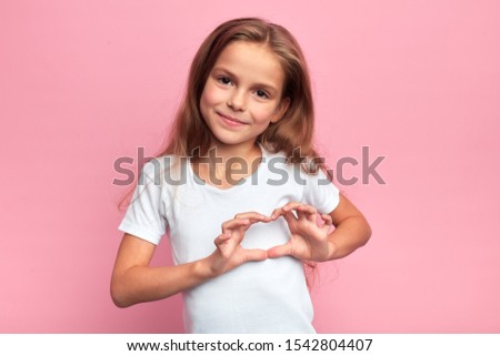 Portrait of young smiling beautiful blonde girl making heart with palms. close up portrait, isolated pink background, body language. reaction, love, positive feeling and emotion