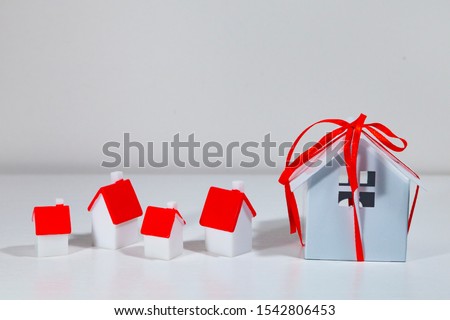 Small houses with red covers.Concept: buying, selling and renting real estate.