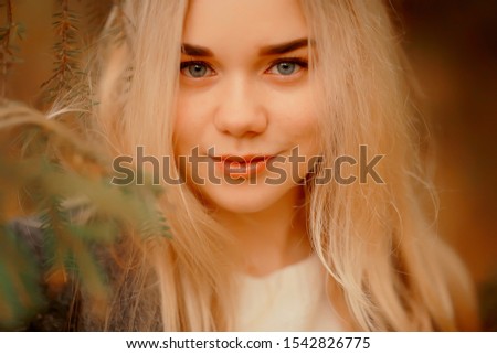 blonde nature portrait autumn, beautiful young adult girl with long hair