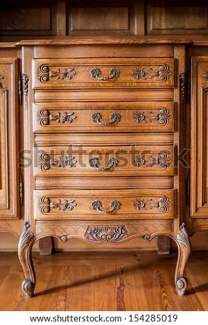 Antique wood carved chest of drawers Royalty-Free Stock Photo #154285019