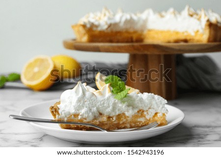 Delicious lemon meringue pie served on white marble table