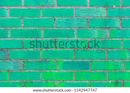 Brick wall painted in bright turquoise color. The texture of the brickwork.