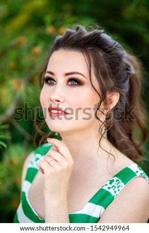 Beautiful brunette girl on walk, portrait photo