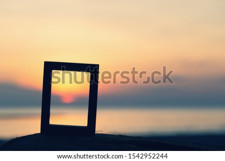 Picture frames placed on sandy beaches
during the time Sunset concept idea background nature style abstract
