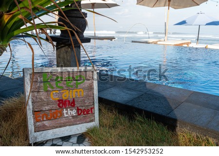 keep carm and enjoy the beer sign buy the pool in bali