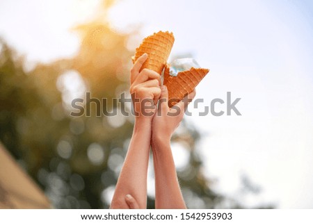 Two children holding in hands ice cream cones