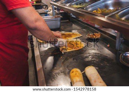 Chef preparing and making Traditional Turkish Doner Kebab meat. Shawarma or gyros. Turkish, greek or middle eastern arab style chicken doner kebab food on isolated white.