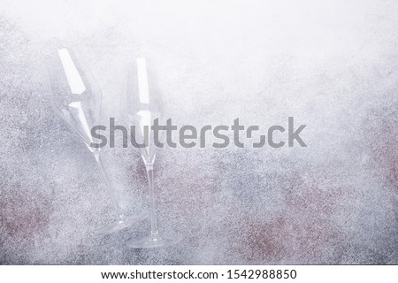 Champagne glasses on light stone background Copy space Top view