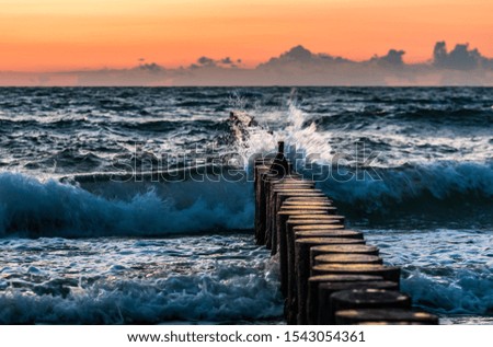 Evening sea coast, waves breaking on breakwater, Baltic sea Poland