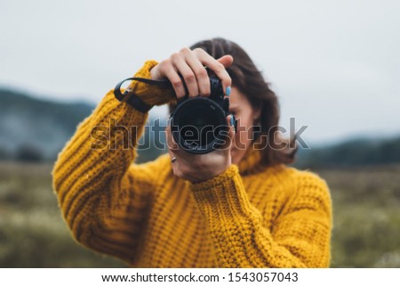 photographer girl take photo on camera closeup on background autumn foggy mountain, tourist shooting nature mist landscape, hobby concept, copy space