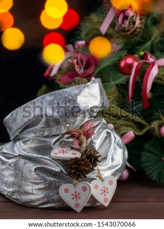Christmas and New Year Celebration with a Magic  Bag with Presents and Shiny Decoration on the Christmas Tree Background. 