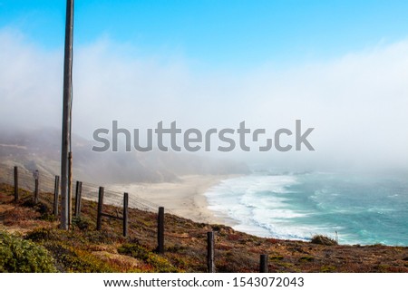 waves rolling in on a beach during fog