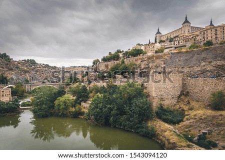 Panoramic view of Toledo old town with Alcazar castle at sunset, Castilla-La Mancha, Spain