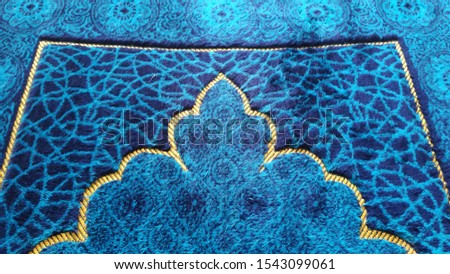 Muslim prayer rug background with blue color Royalty-Free Stock Photo #1543099061