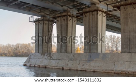 Concrete bridge and river. Autumn landscape.