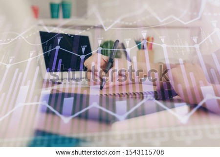 Financial graph displayed on woman's hand taking notes background. Concept of research. Double exposure